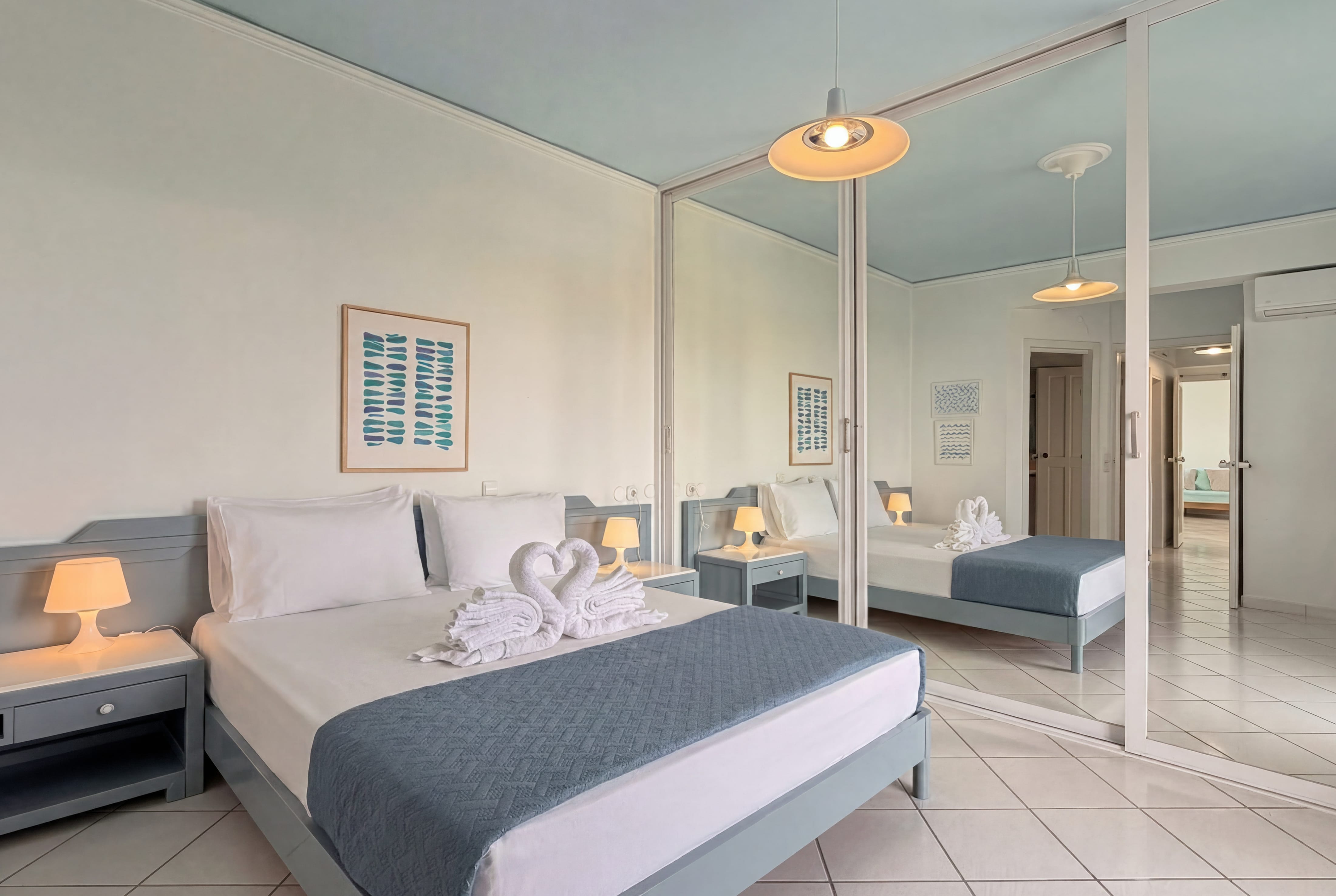 a bedroom with a mirror and a bed