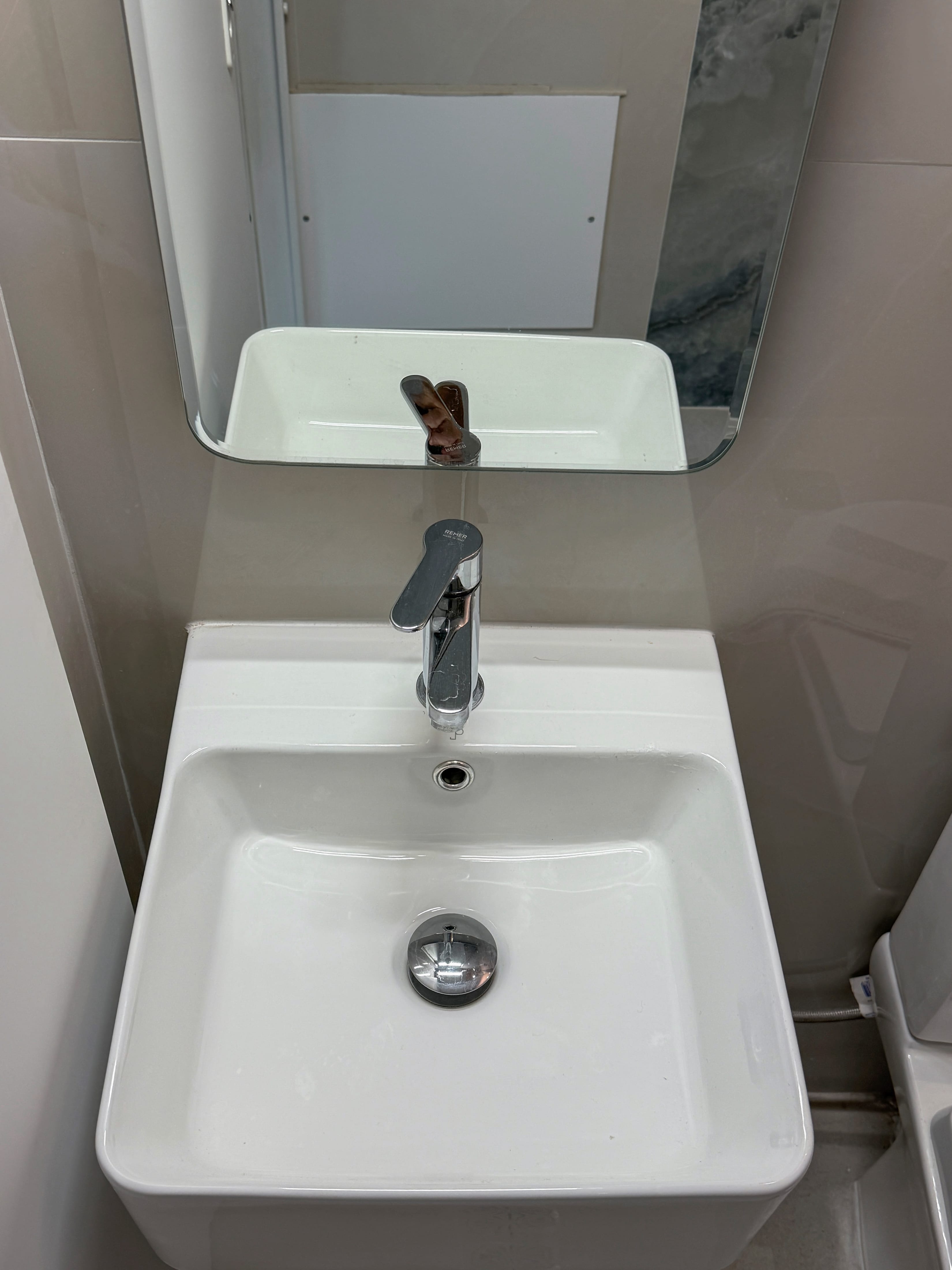 a sink with a mirror above it