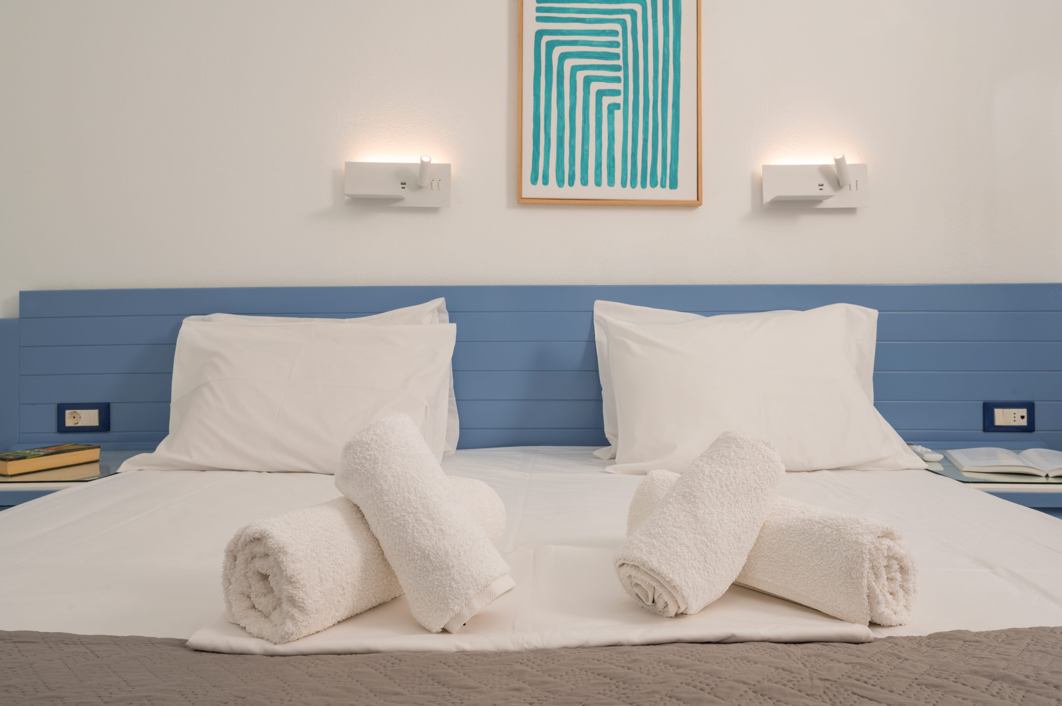 a bed with rolled up towels