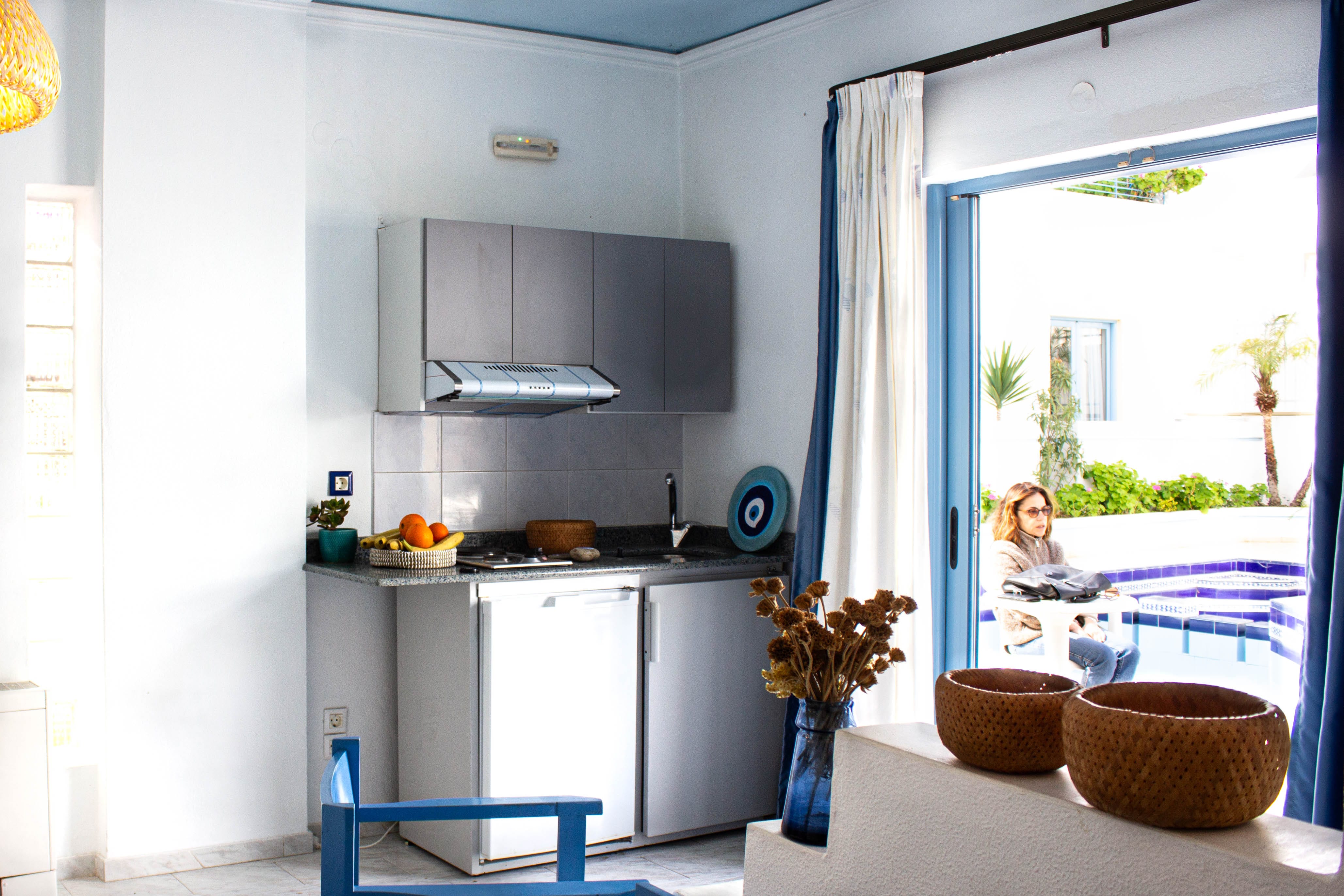 a person sitting at a table in a kitchen