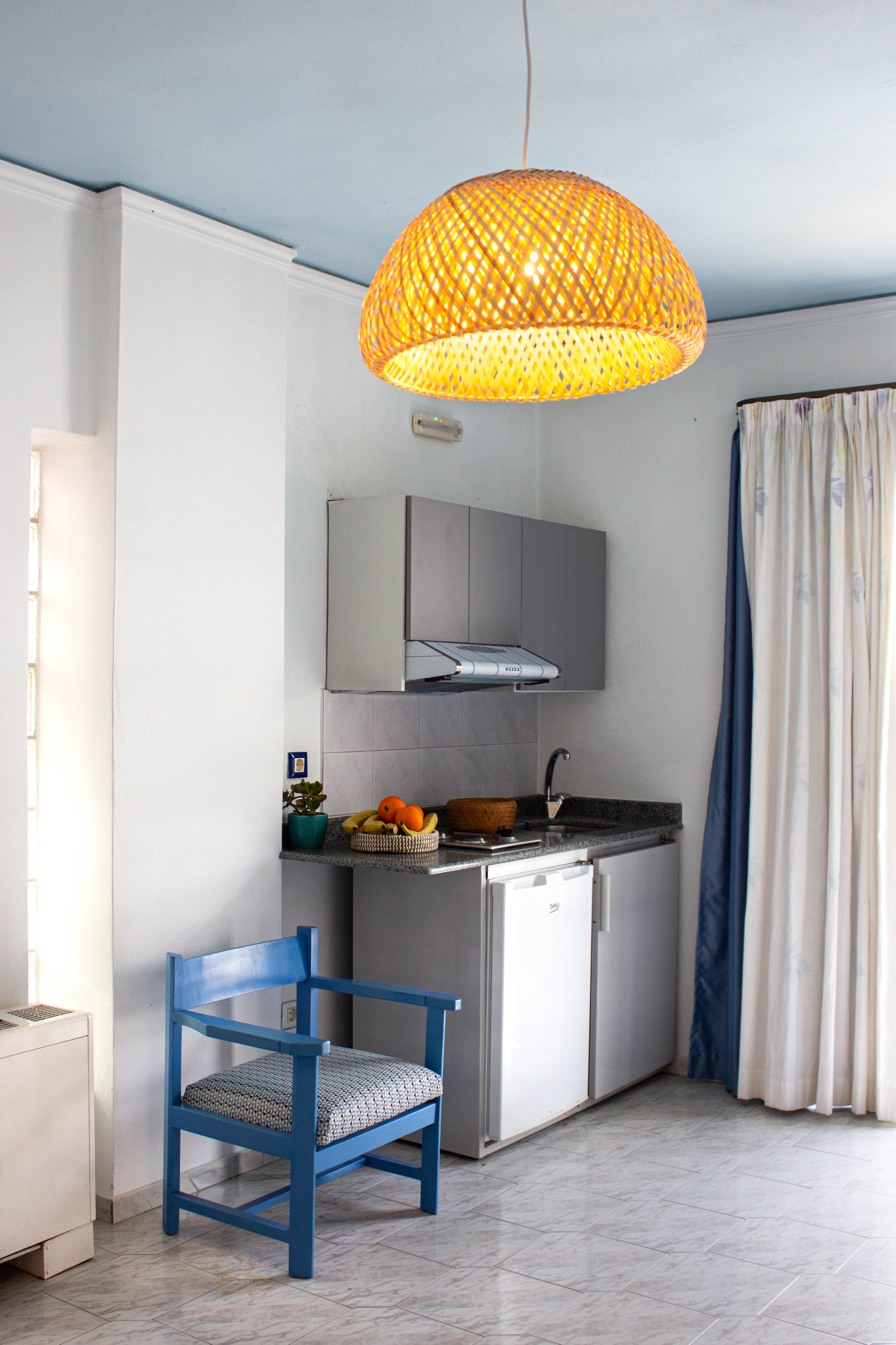 a kitchen with a yellow lamp