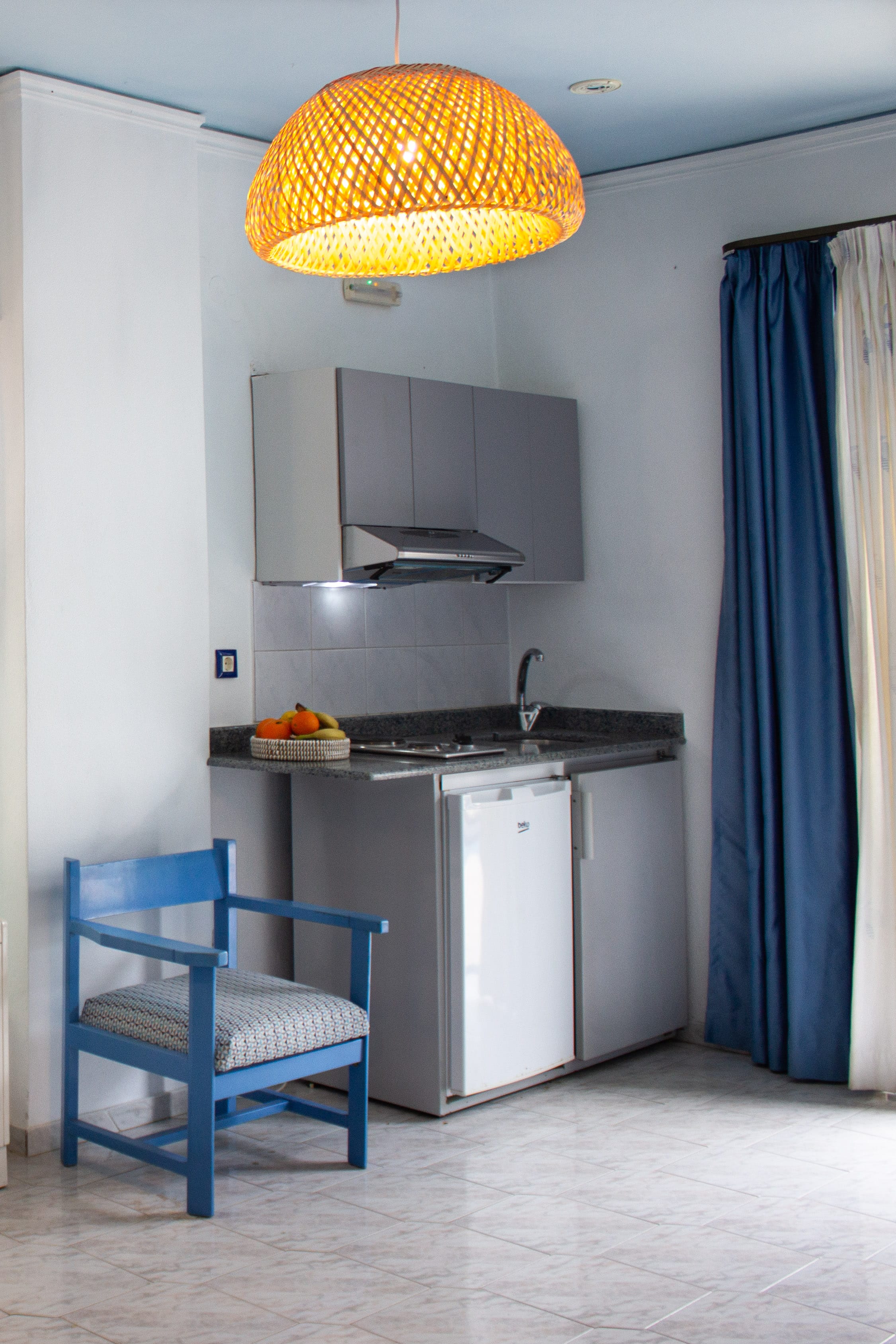 a kitchen with a chair and a table