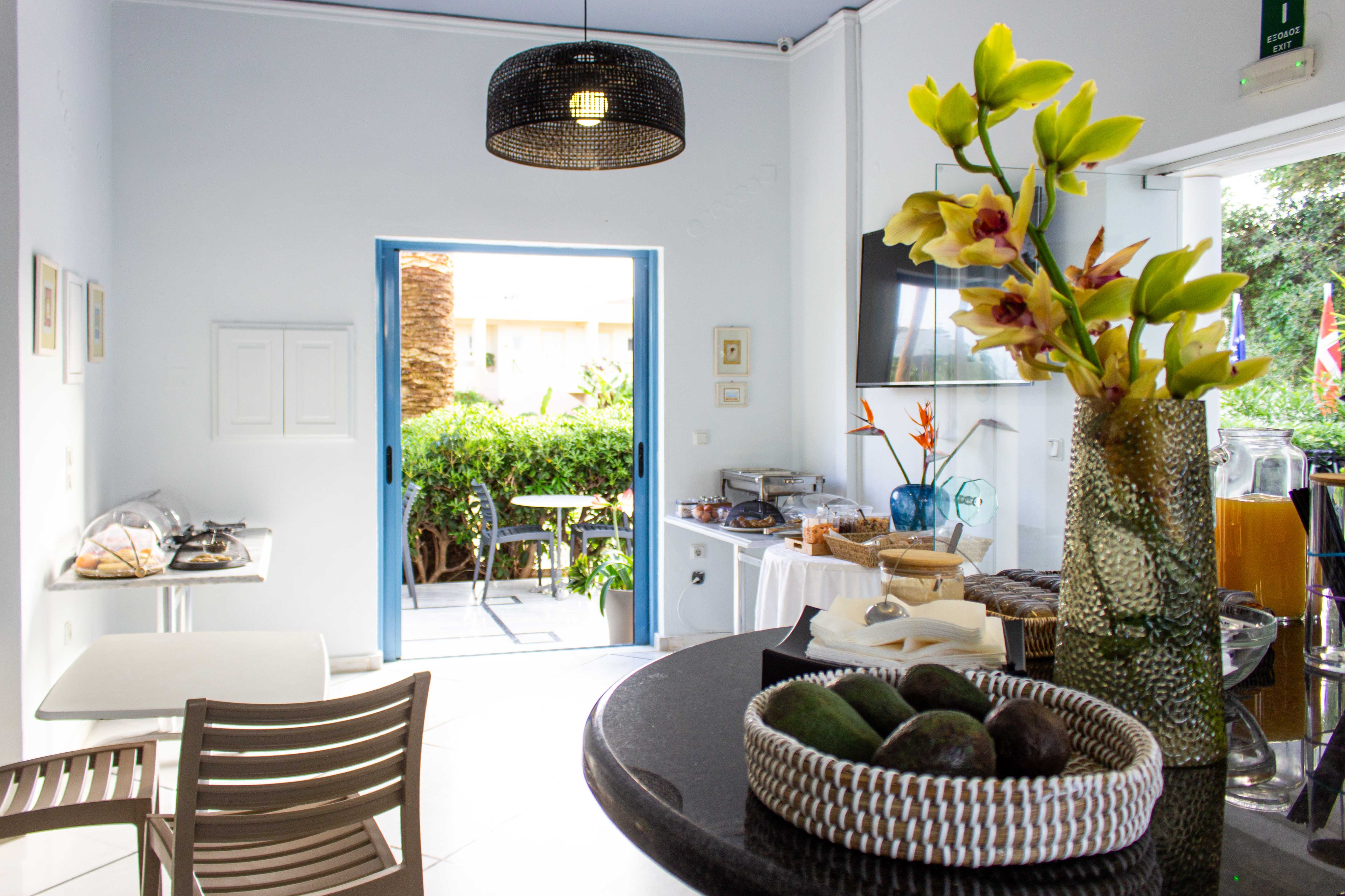 a dining room with a basket of fruit and a vase of flowers