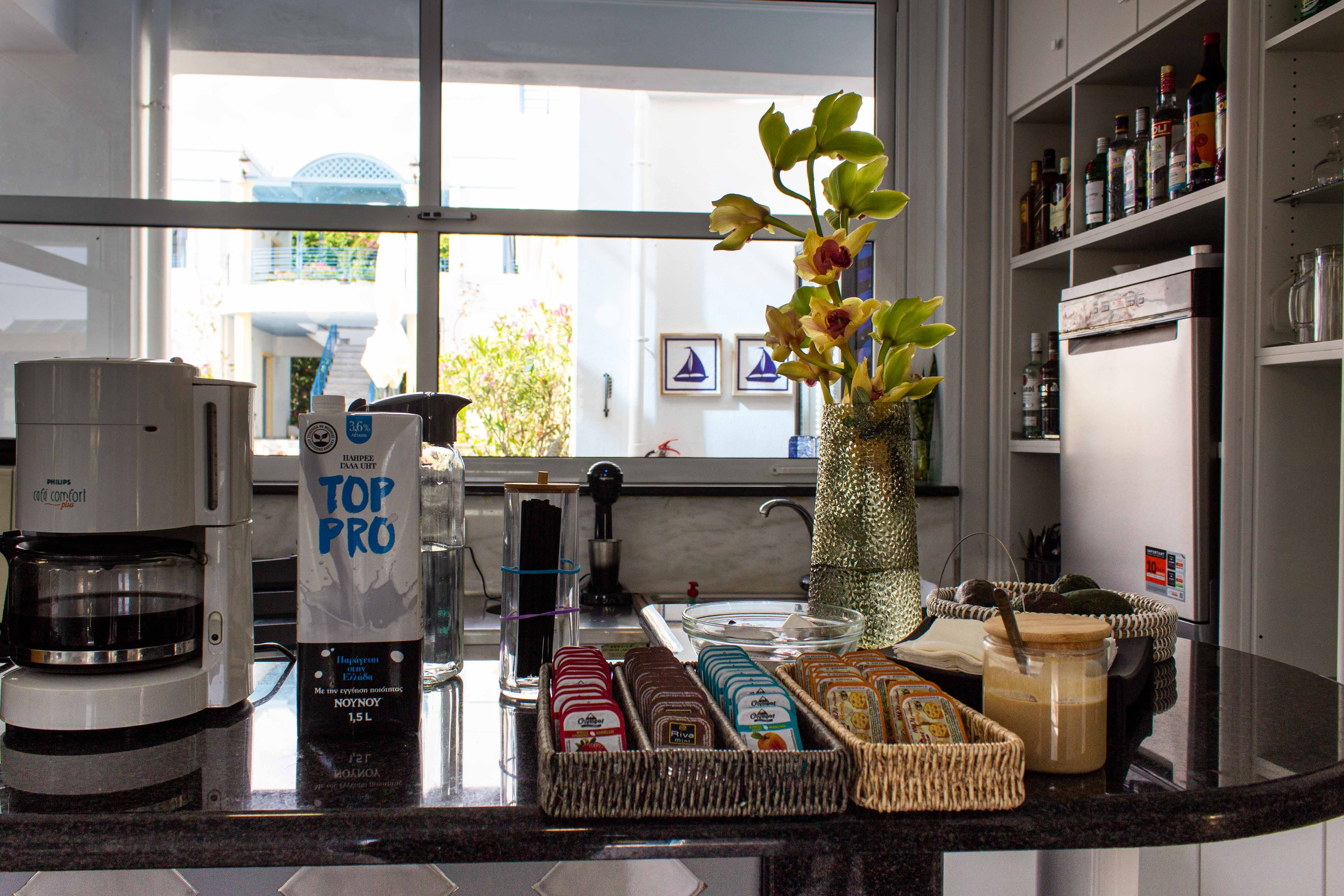 a vase with yellow flowers on a kitchen counter