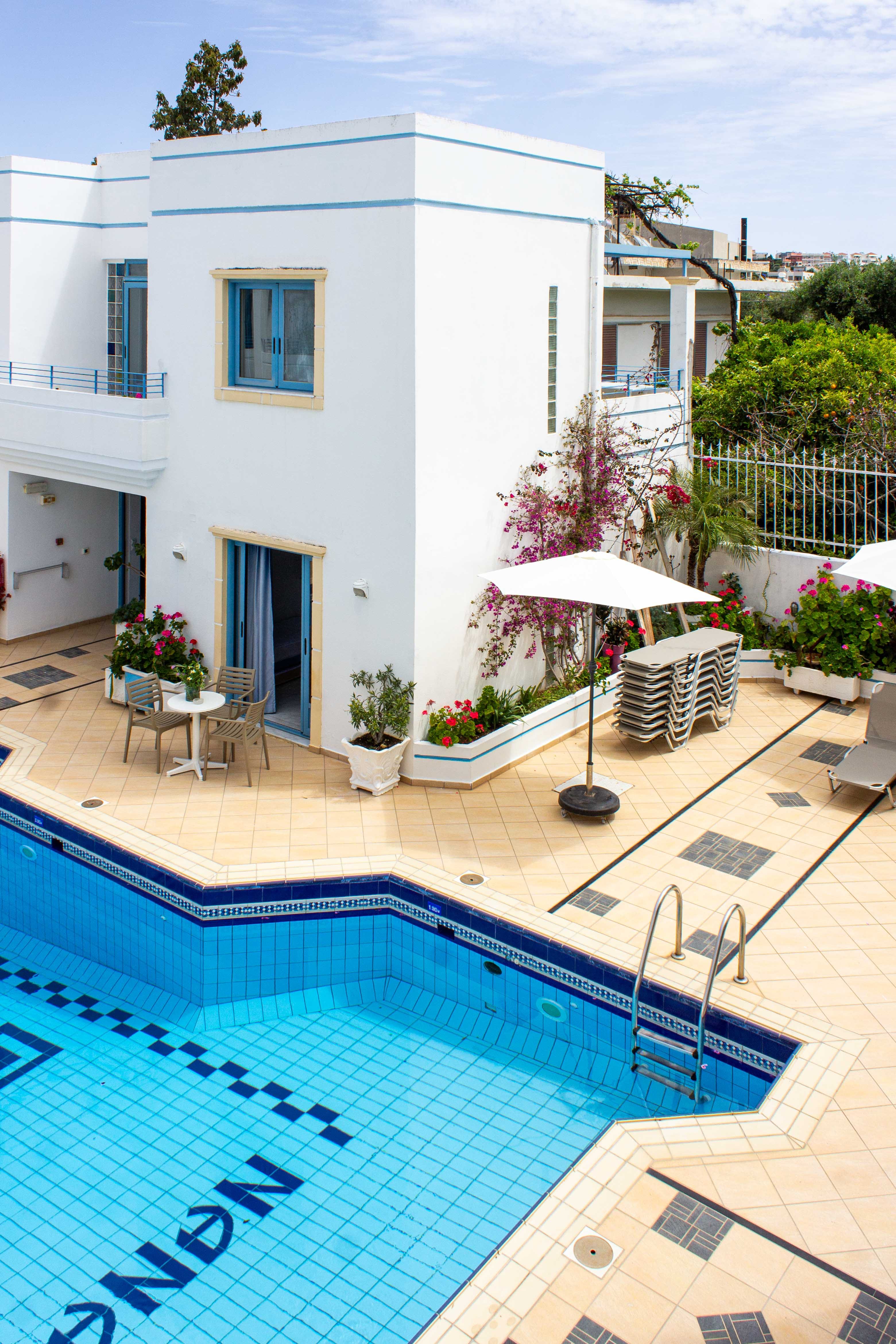 a pool with a deck and chairs