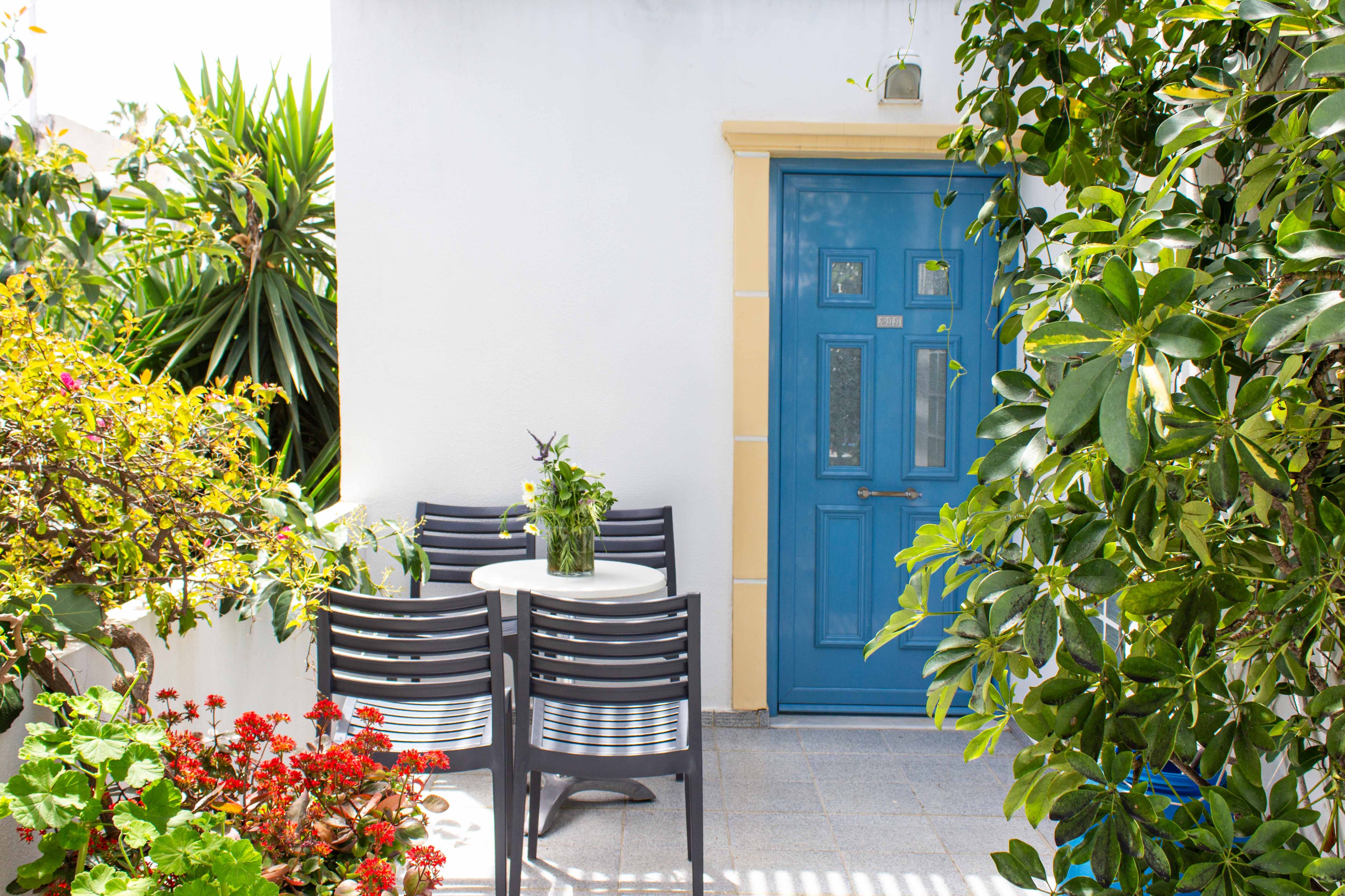 a patio with chairs and a table