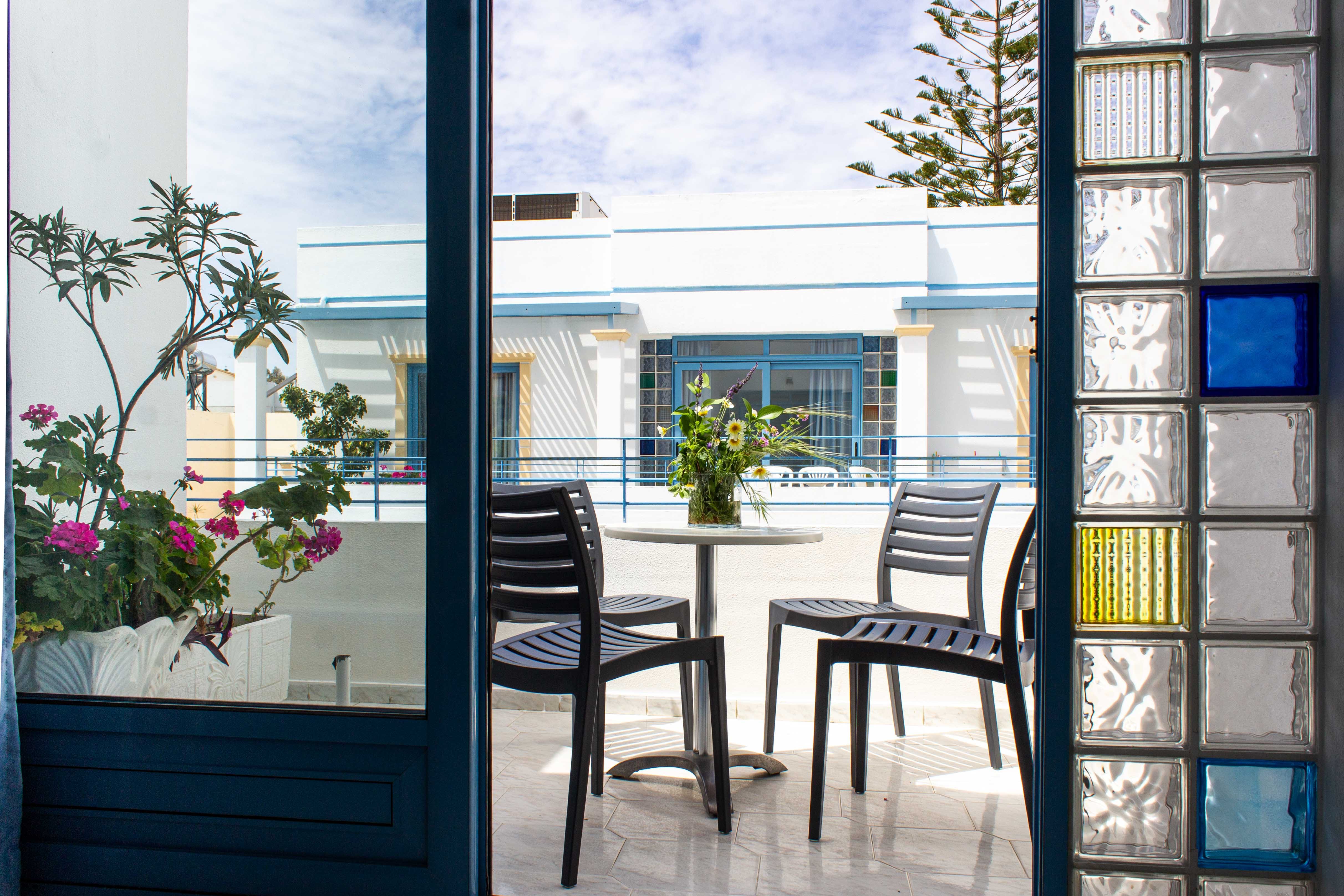 a patio with chairs and a table