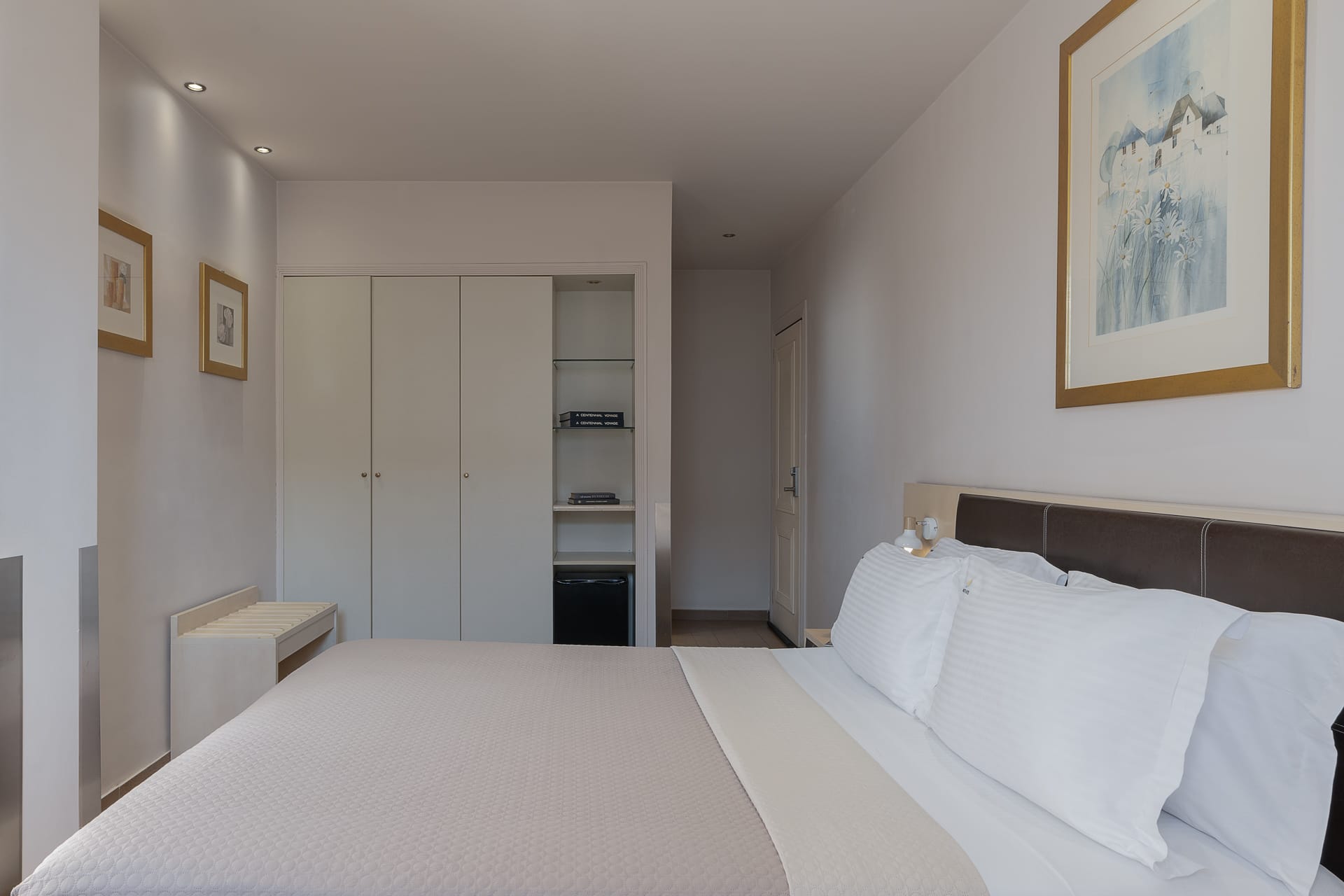 a bedroom with white bedding