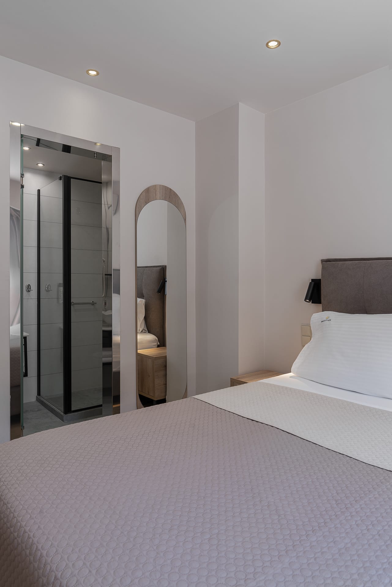 a bedroom with a large mirror
