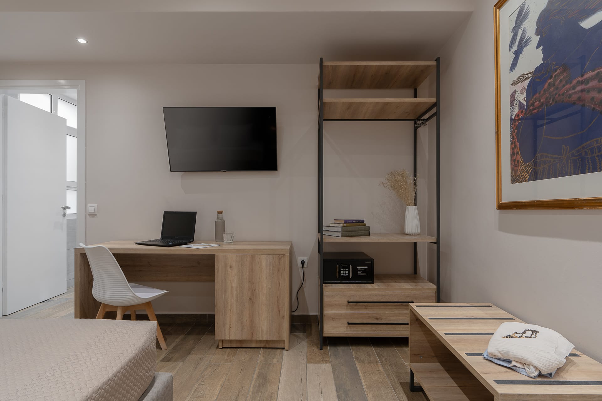 a room with a desk and a tv