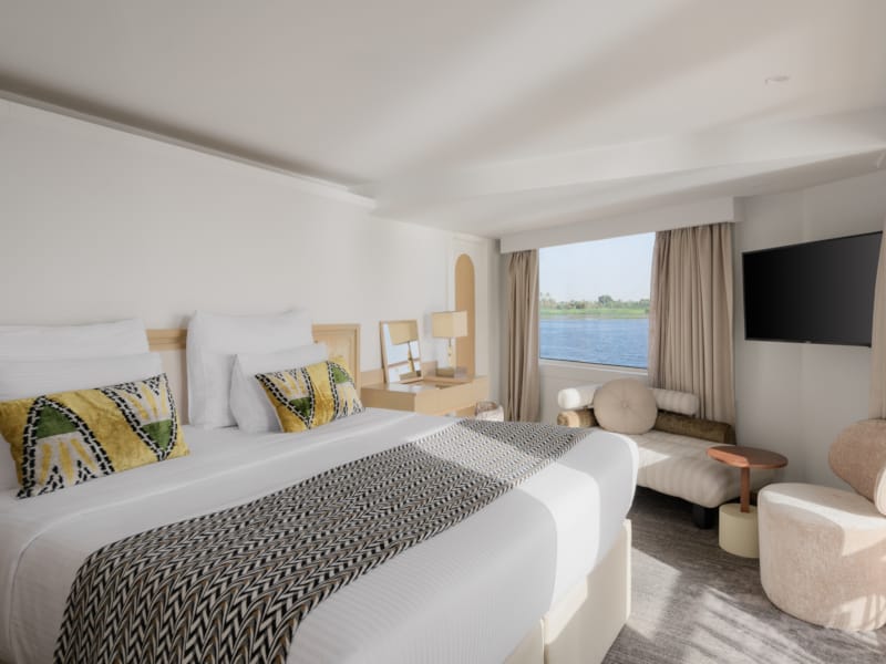 a bedroom with a large bed and a tv