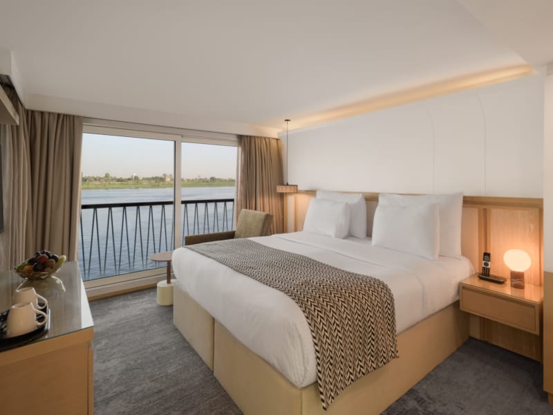 a bedroom with a large balcony