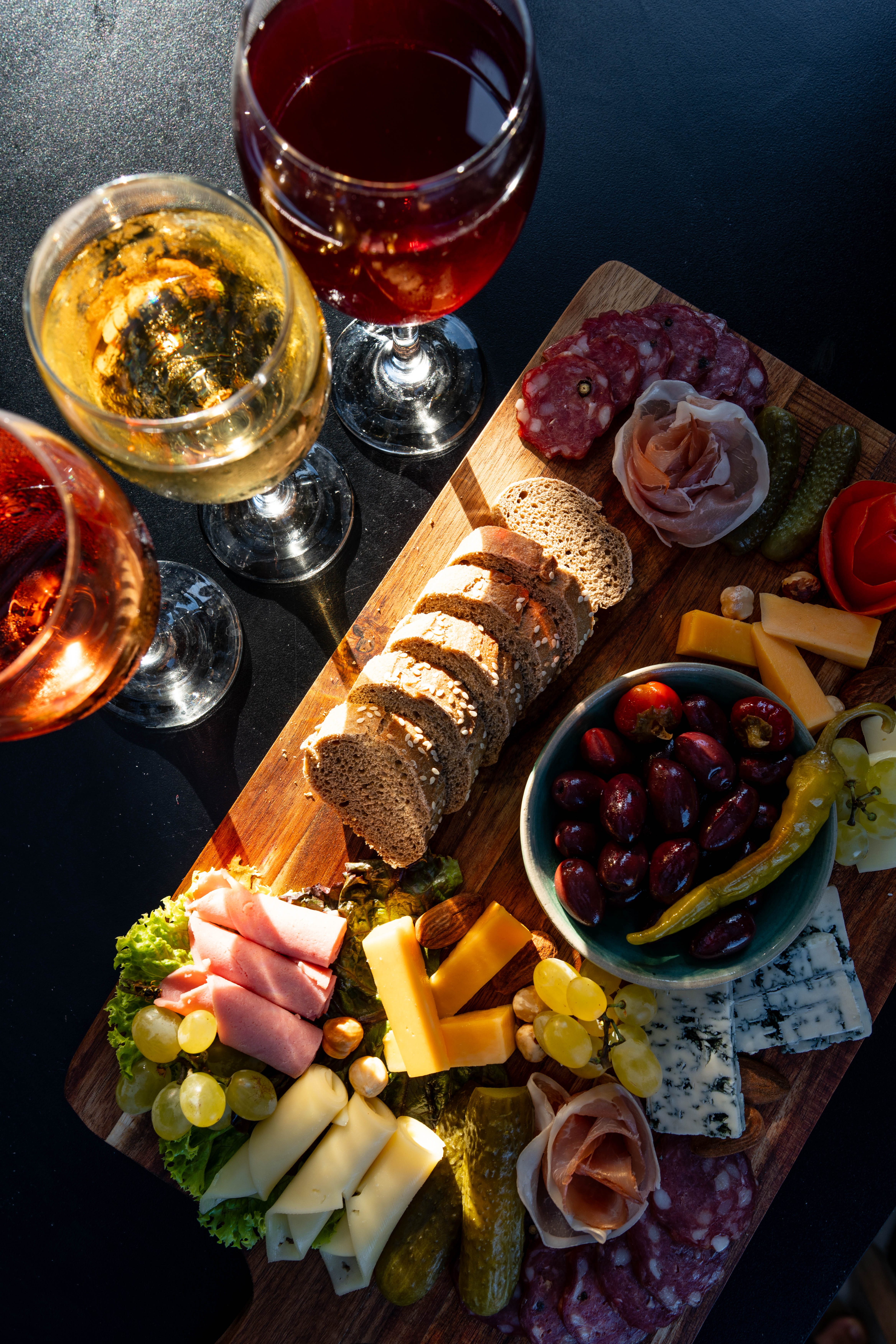 a plate of food and glasses of wine