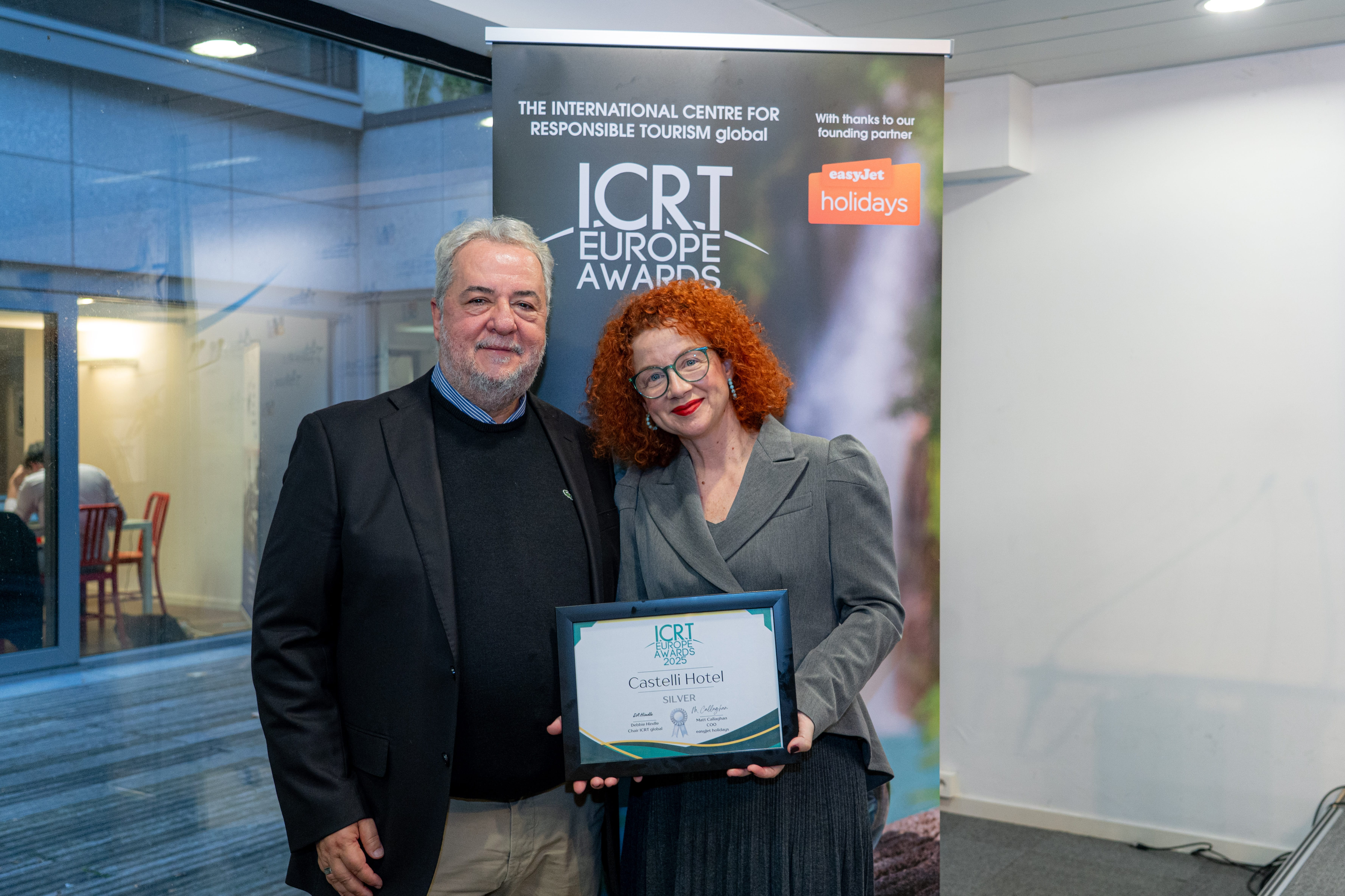 a man and woman holding a framed picture