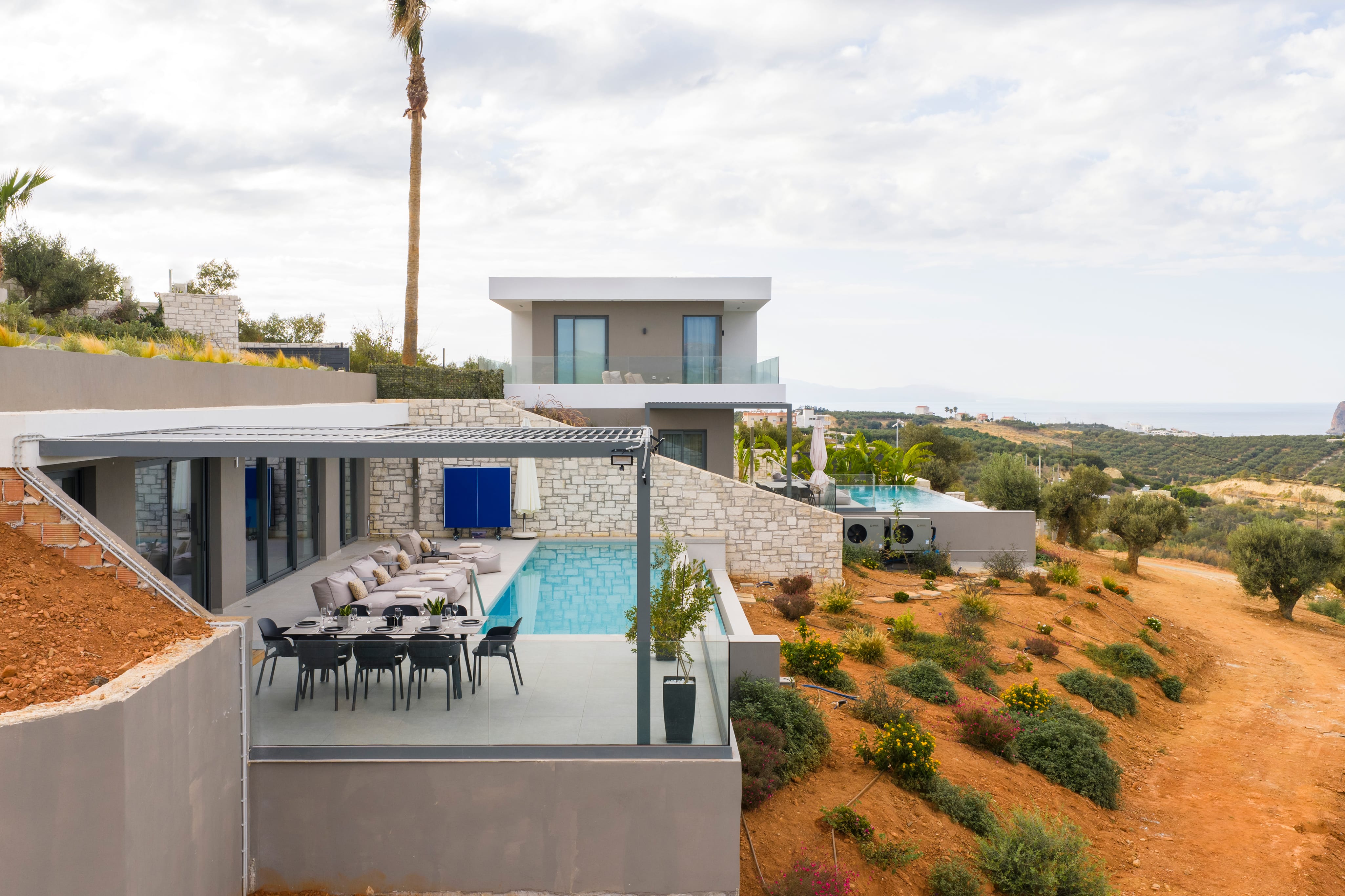 a house with a pool and chairs