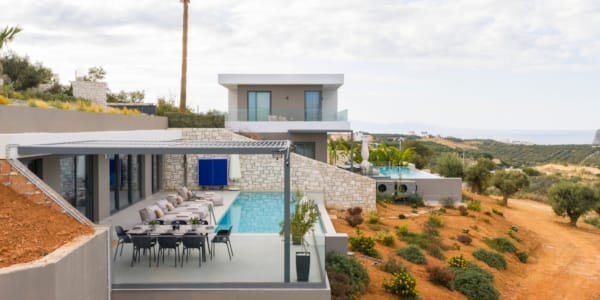 a house with a pool and chairs