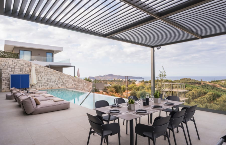 a table with chairs and a pool