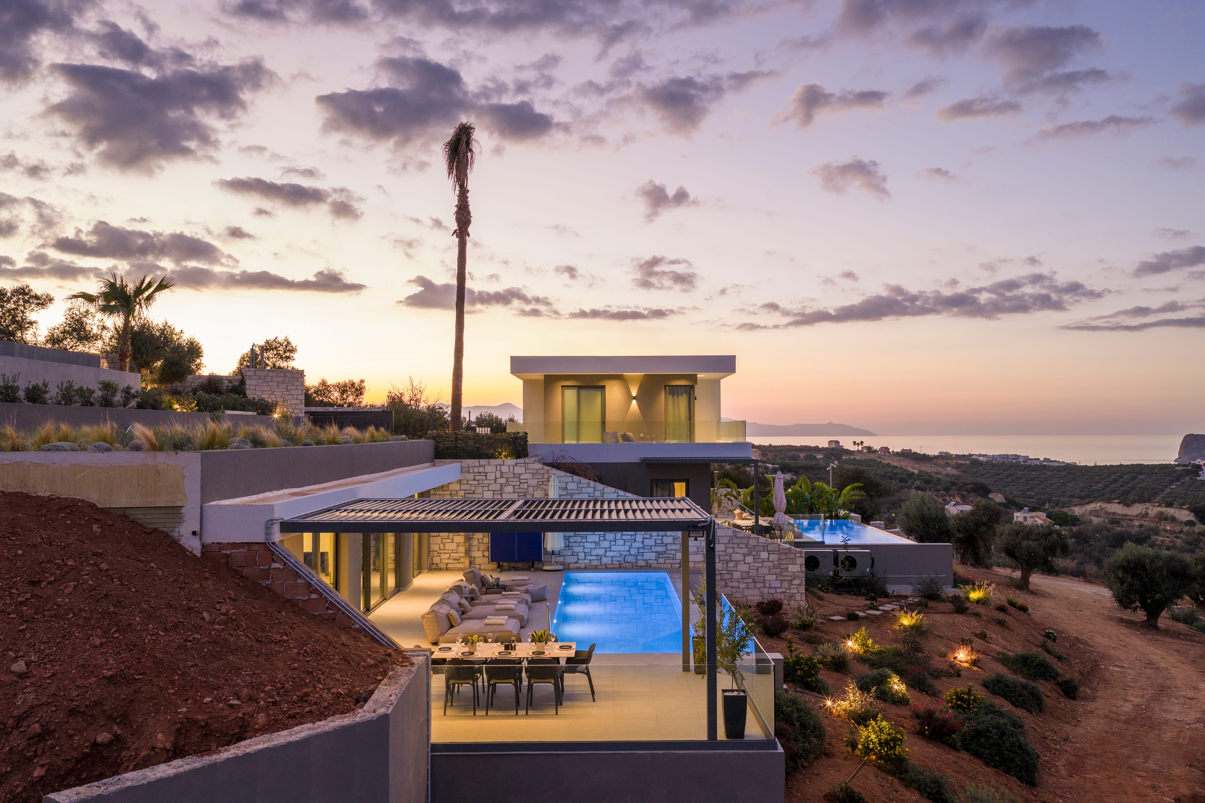 a house with a pool and trees around it