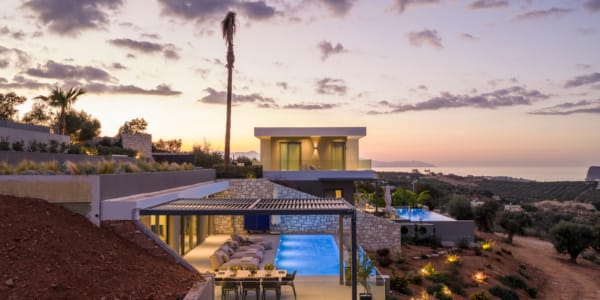 a house with a pool and trees around it