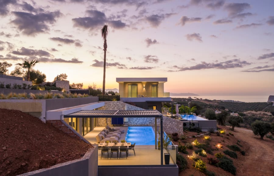 a house with a pool and trees around it