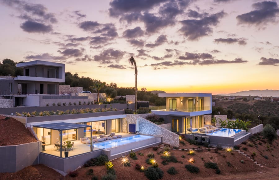 a building with a pool and a sunset in the background