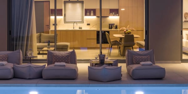 a room with a pool table and chairs