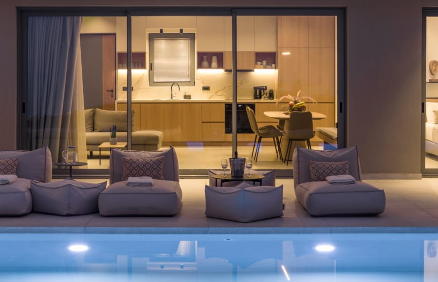 a room with a pool table and chairs