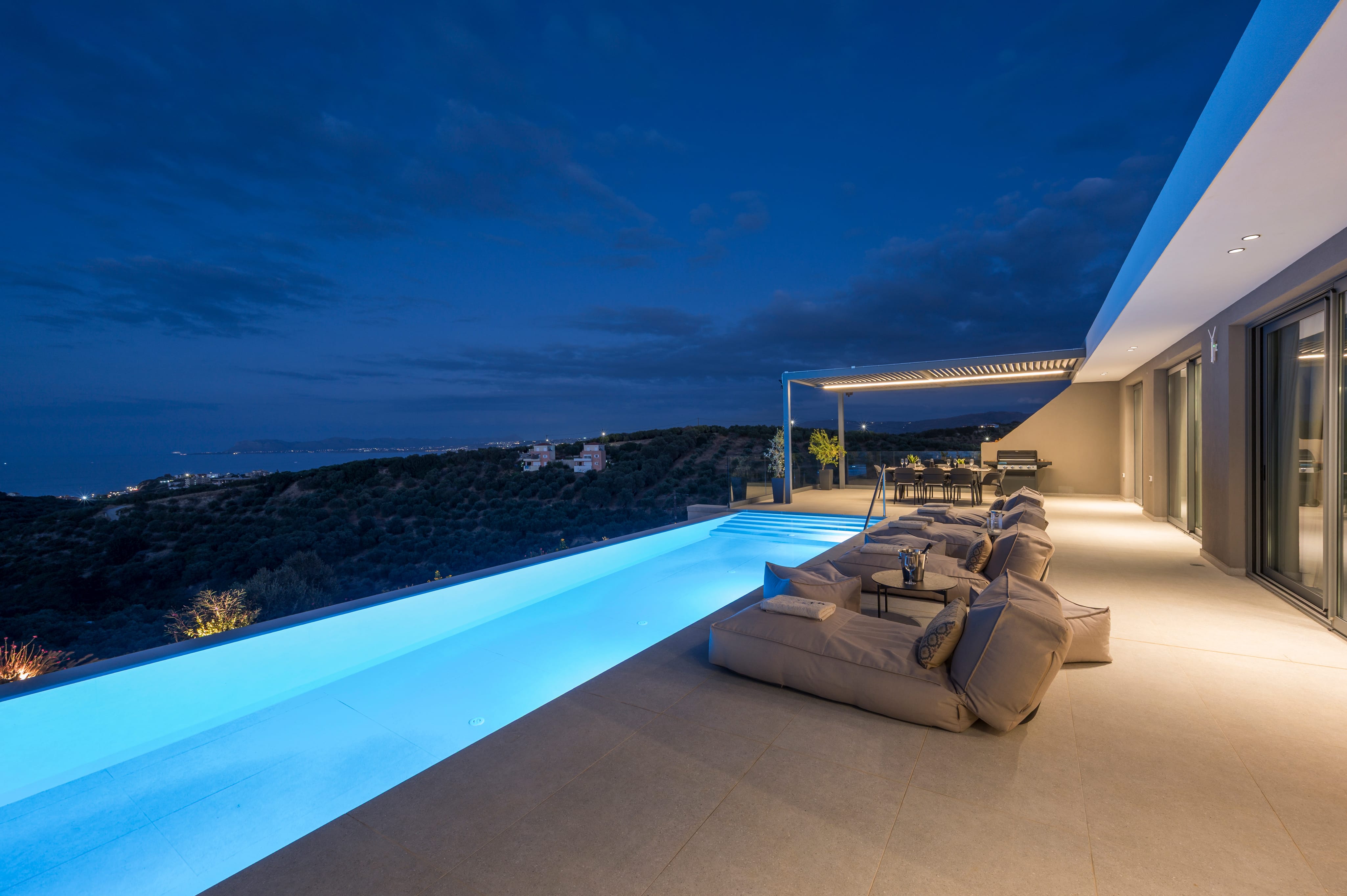 a deck with a pool and a view of the ocean