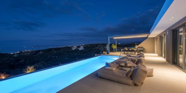 a deck with a pool and a view of the ocean