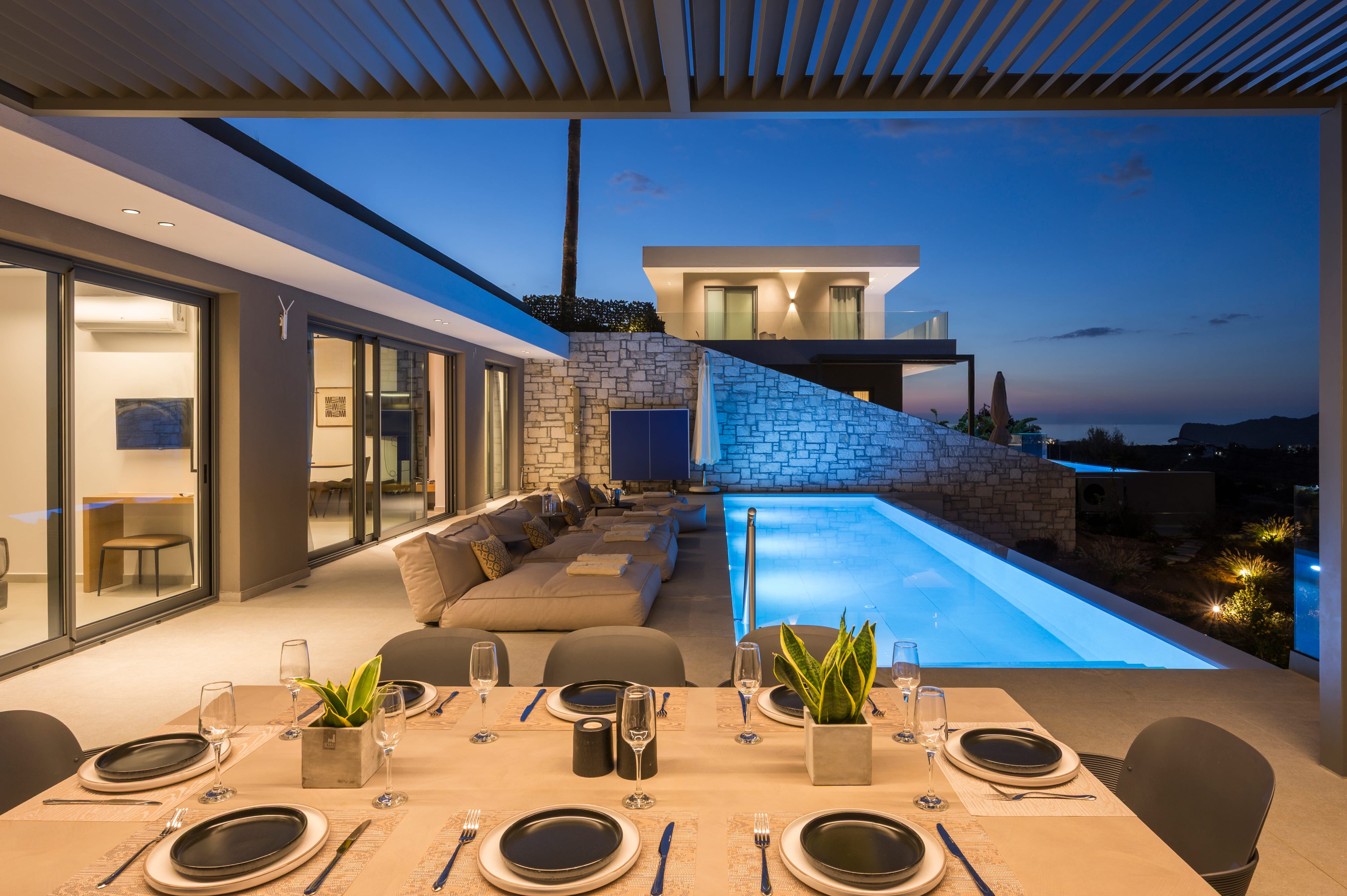 a swimming pool with chairs and a table