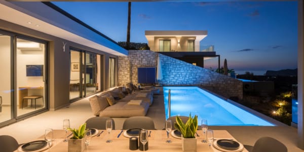 a swimming pool with chairs and a table