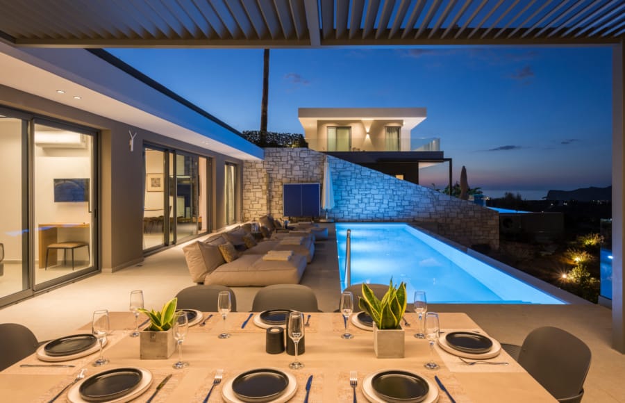 a swimming pool with chairs and a table