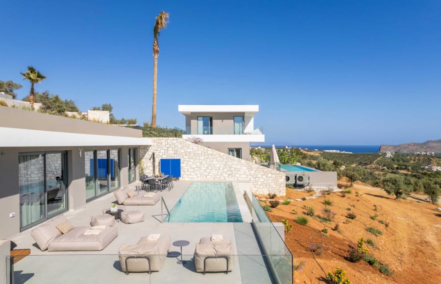 a building with a pool and chairs