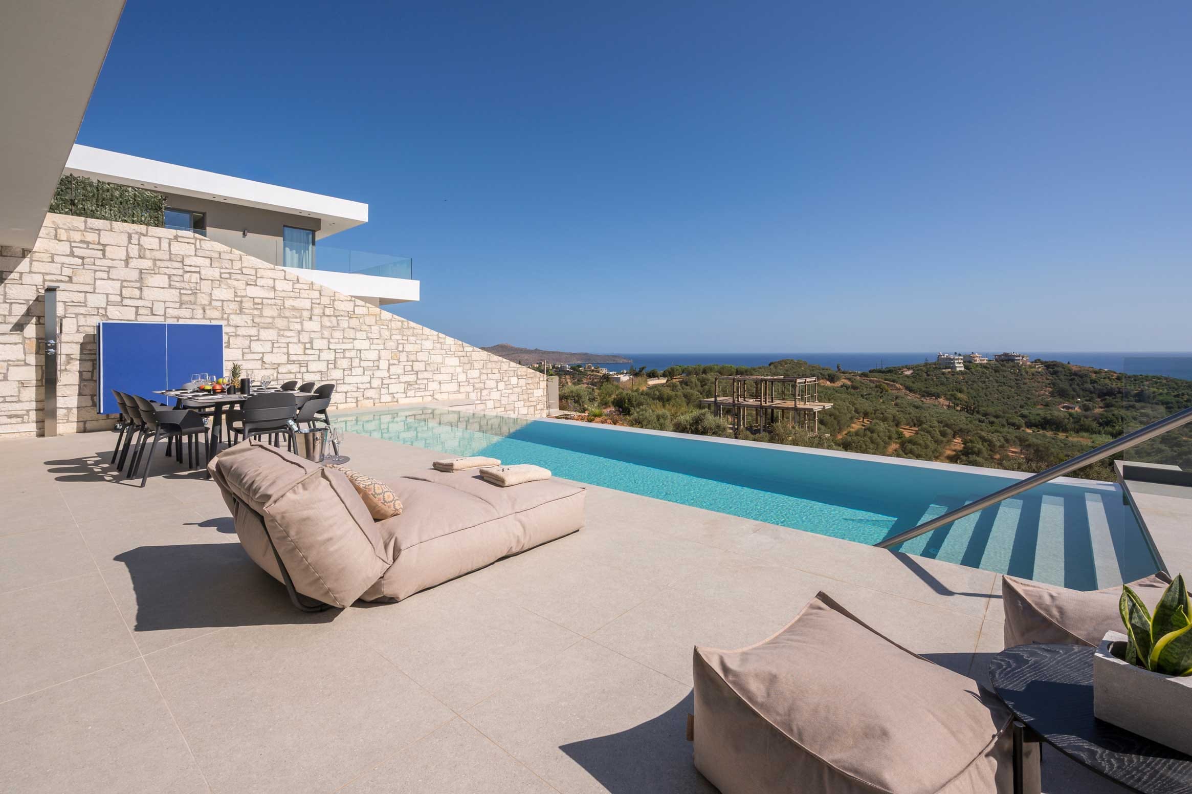 a pool with a deck and chairs