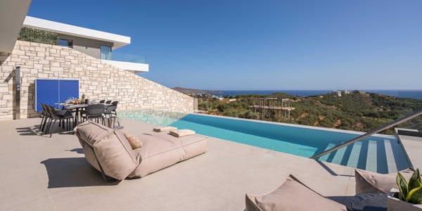 a pool with a deck and chairs