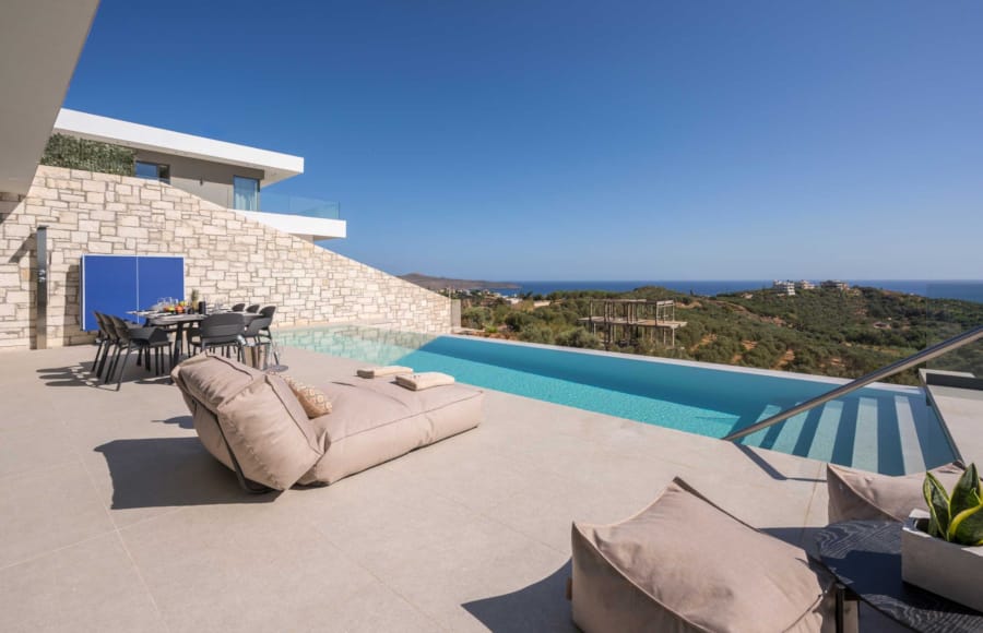 a pool with a deck and chairs