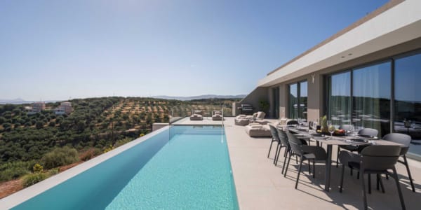 a pool and chairs on a deck