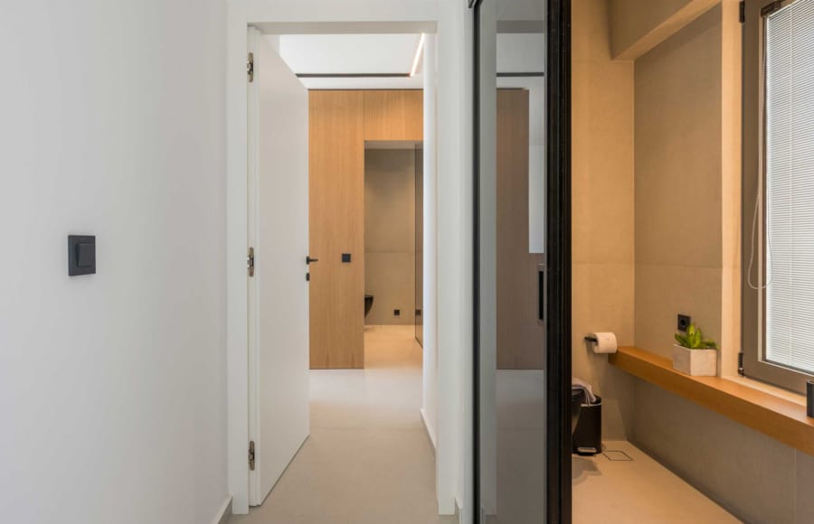 a hallway with a door and a mirror