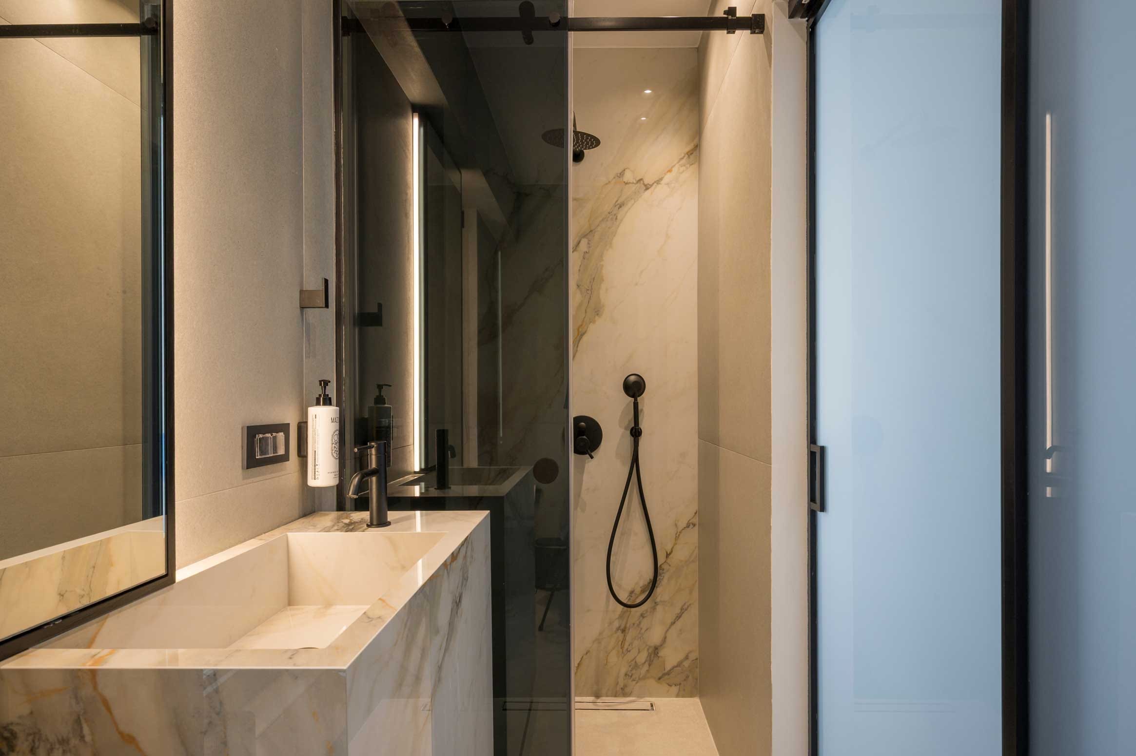 a bathroom with a shower unit and sink