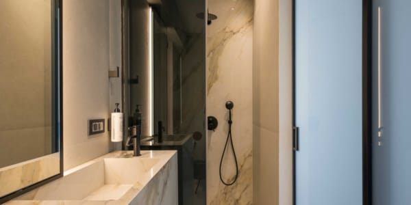 a bathroom with a shower unit and sink