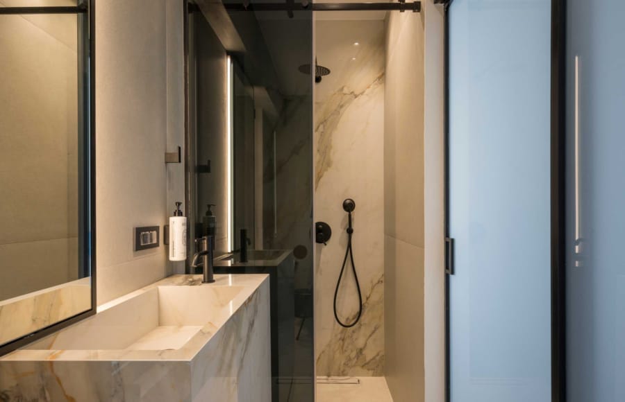 a bathroom with a shower unit and sink
