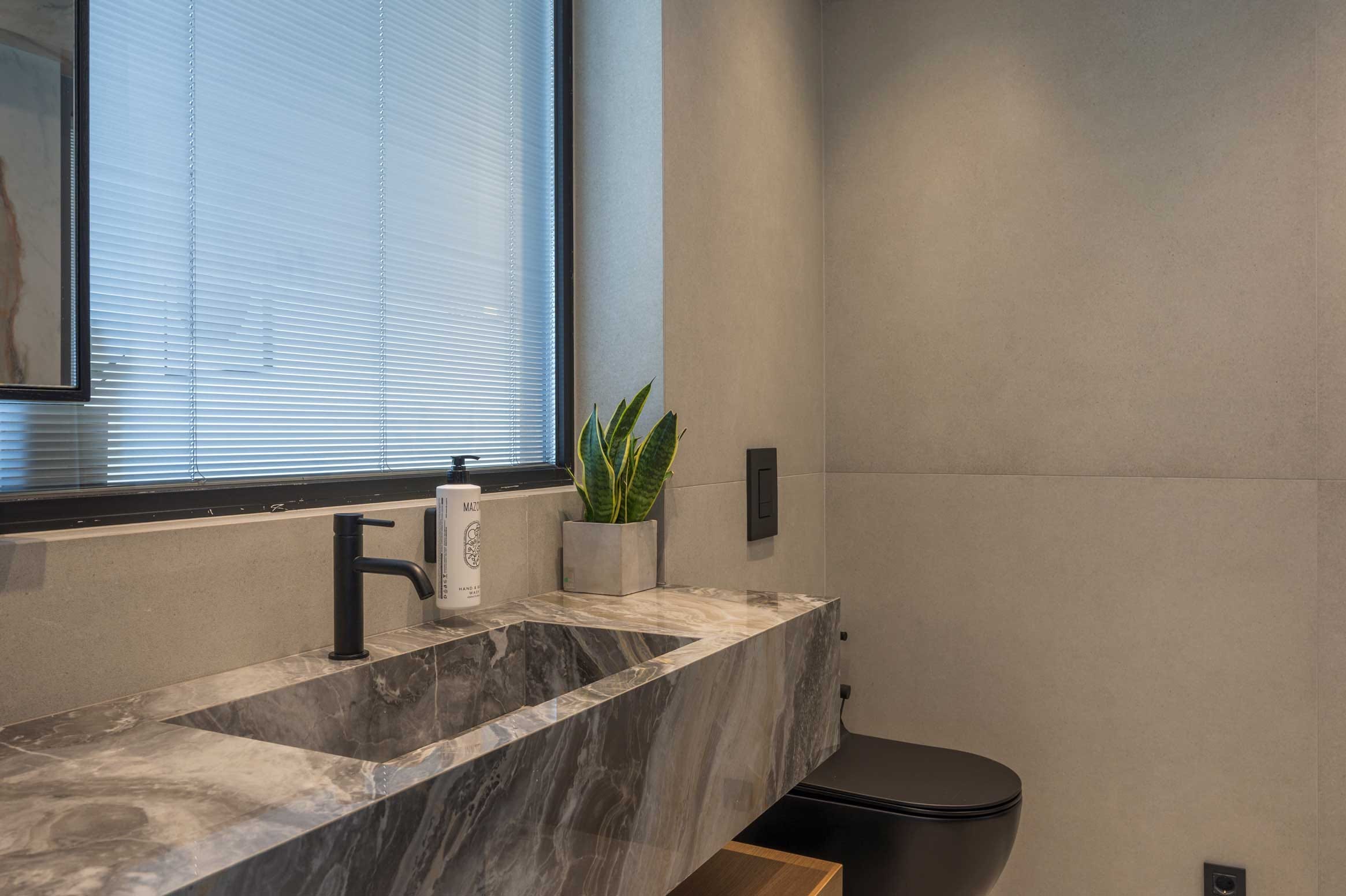 a bathroom with a plant on the counter
