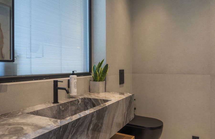 a bathroom with a plant on the counter