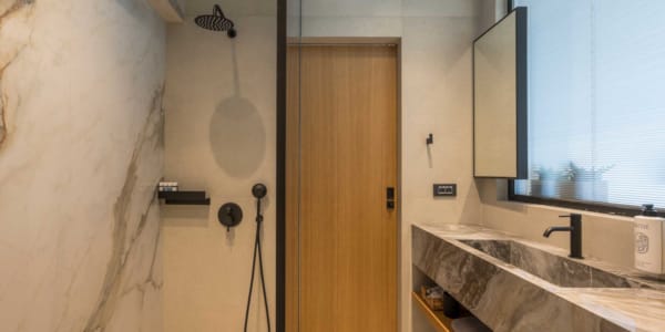 a bathroom with a shower unit and a sink