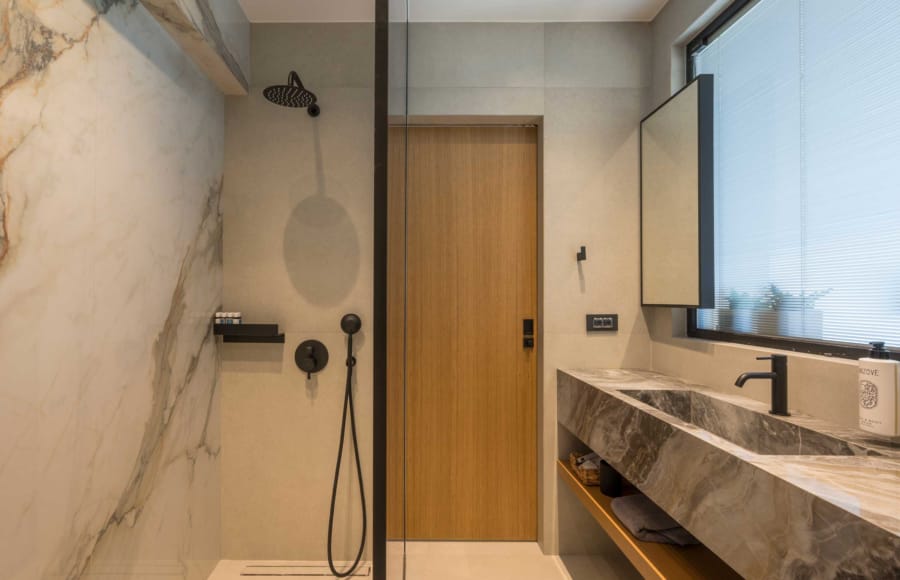 a bathroom with a shower unit and a sink