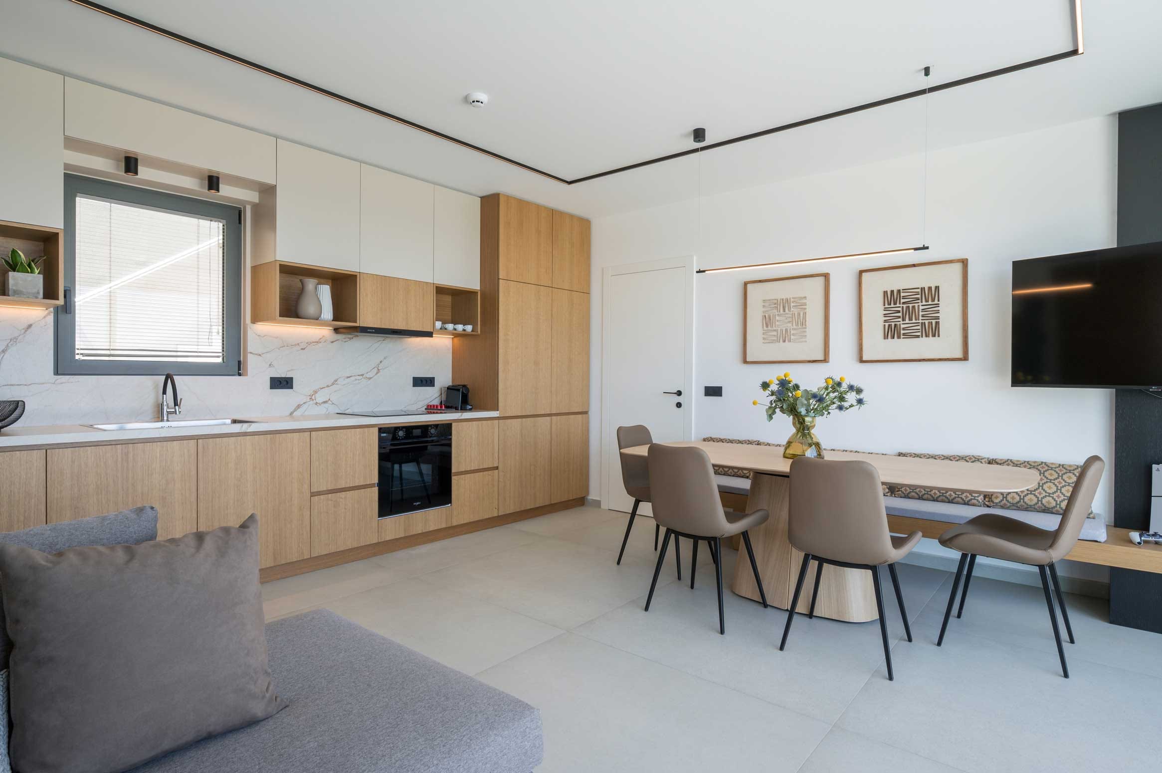 a room with a table chairs and a tv