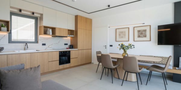 a room with a table chairs and a tv