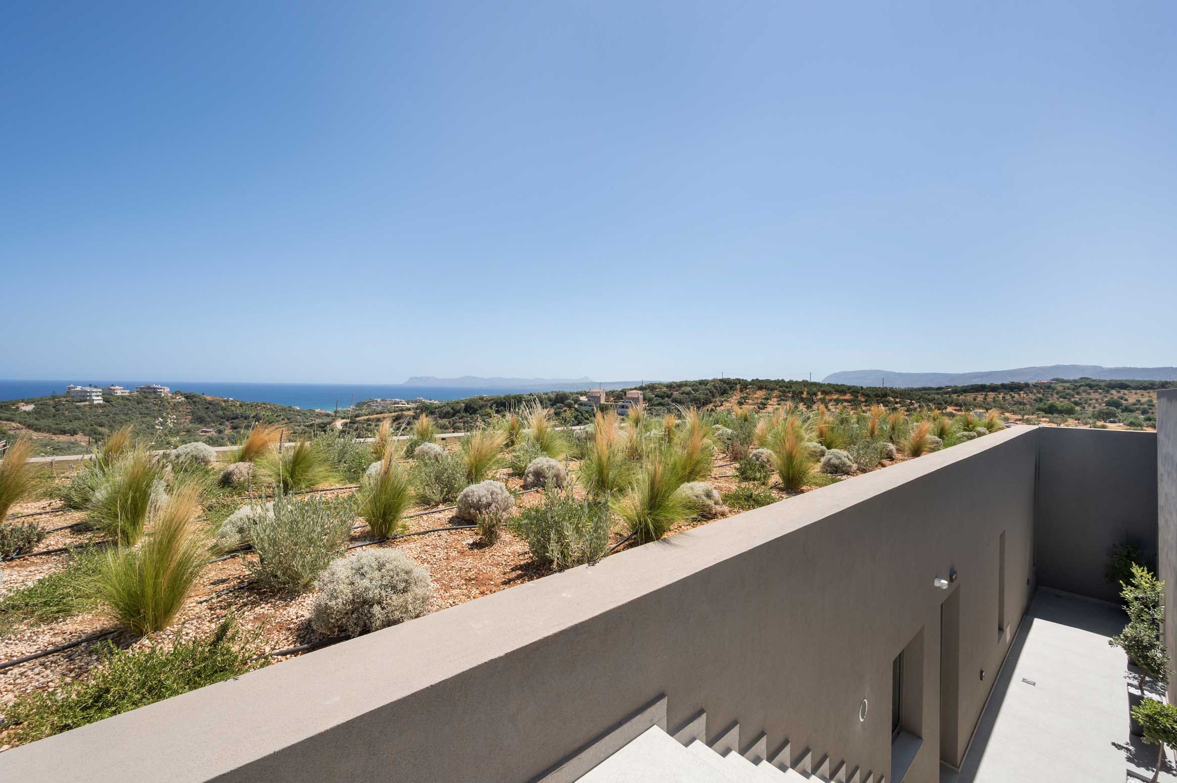 a building with bushes and trees