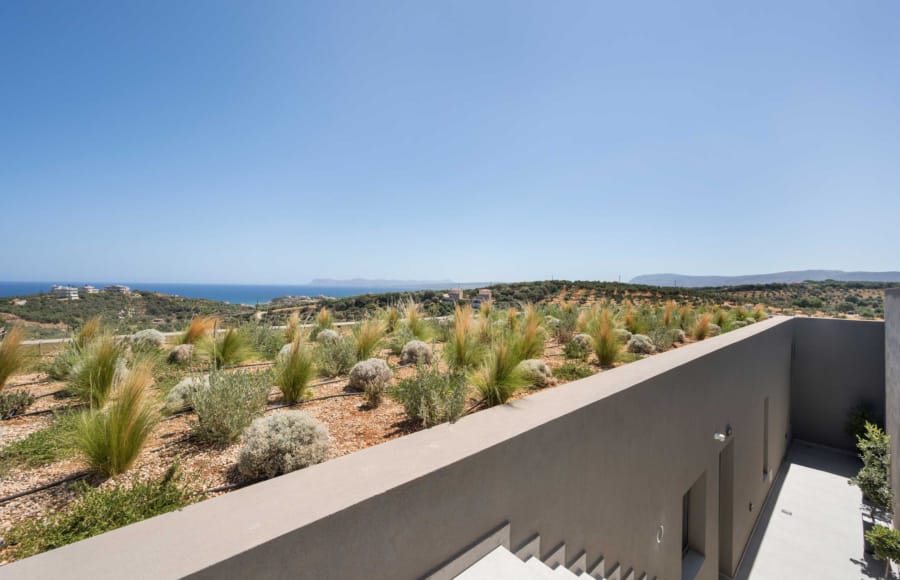 a building with bushes and trees