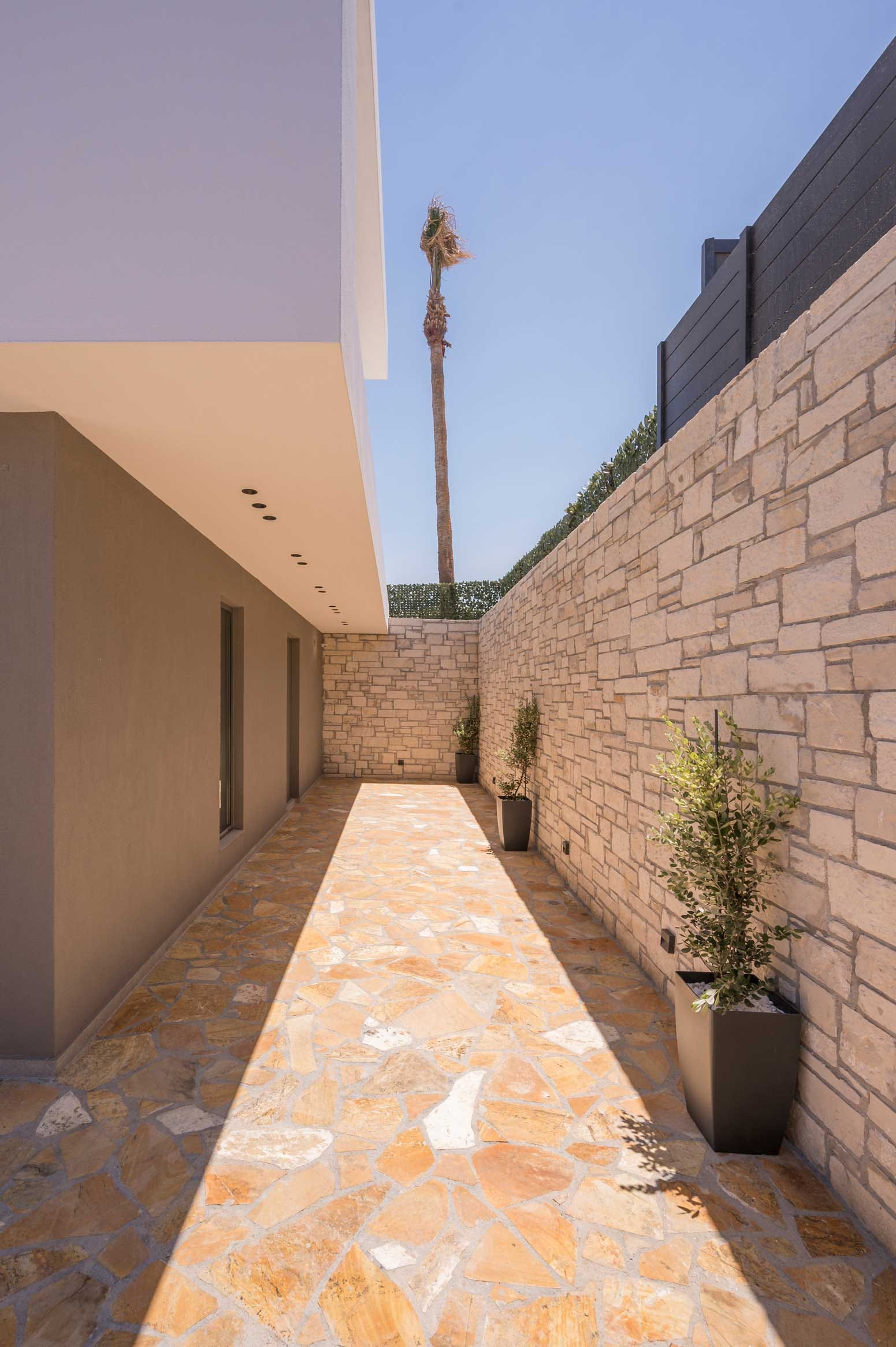 a stone walkway between two buildings